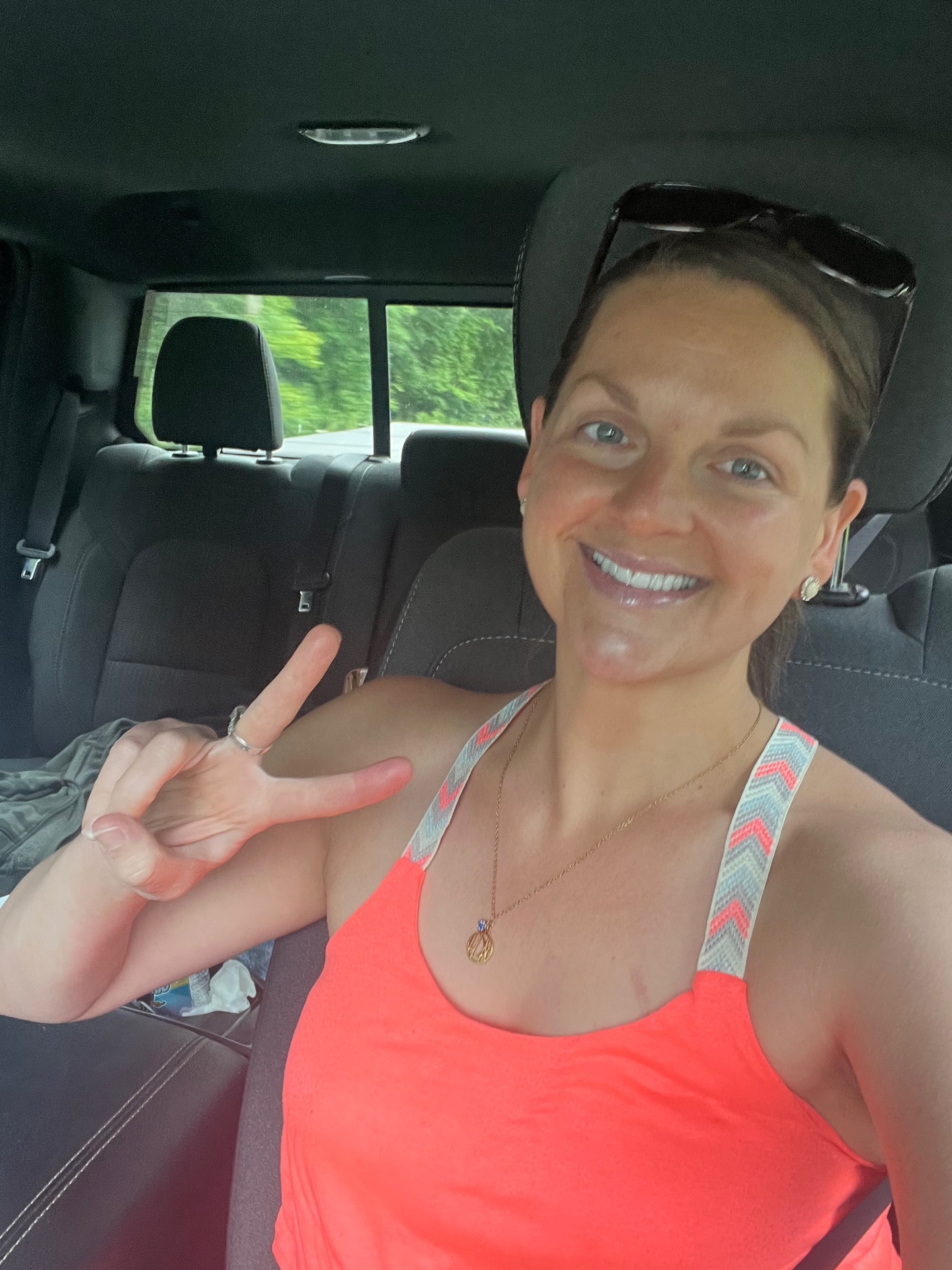 Sarah smiling and giving a peace sign